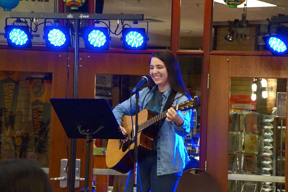 Annie Babcock performing at the 'Rock Fest' coffee house put on by her household, Carae Domini. Photo by Liz Bunnell