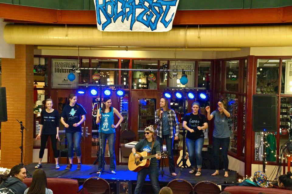 Members of Carae Domini performing in the lip singing battle at their coffee house. Photo by Liz Bunnell.