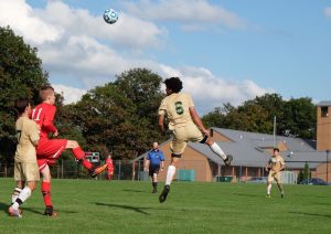 Jacob Rigaud heads a ball and score a goal against D'Youville. (Photo by Ulises Iniguez)